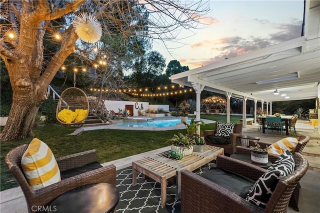 view of patio featuring outdoor dining space, a fenced in pool, and an outdoor hangout area