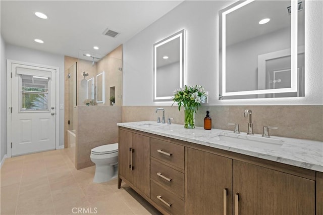 bathroom with visible vents, toilet, and a sink