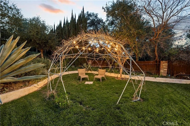 view of jungle gym with a lawn and fence