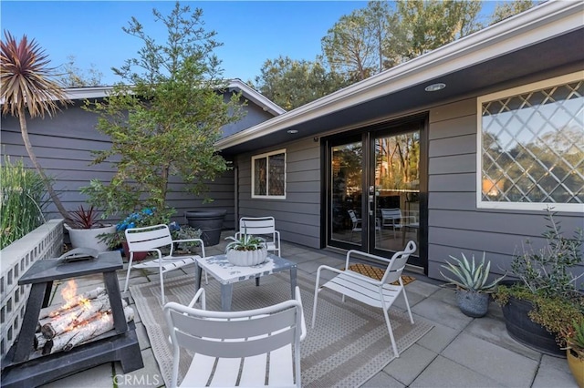 exterior space with an outdoor living space with a fire pit