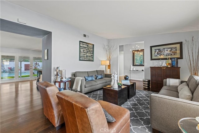 living room with dark wood finished floors and visible vents