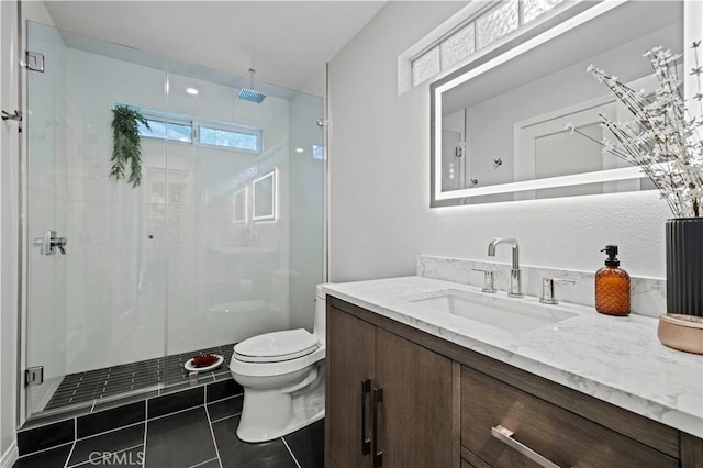 bathroom with tile patterned floors, a shower stall, toilet, and vanity