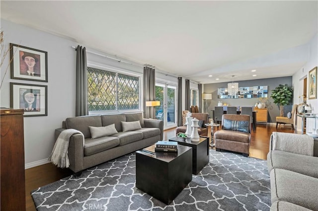 living area with recessed lighting, baseboards, and wood finished floors