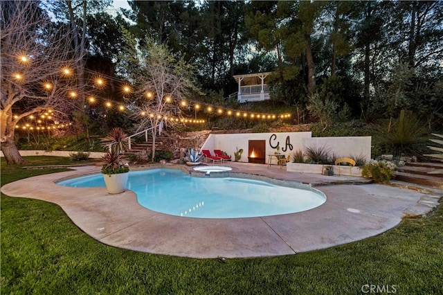 view of pool featuring a pool with connected hot tub and a patio area