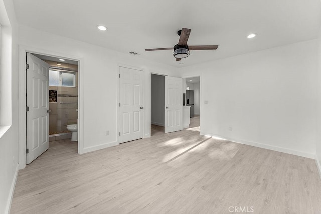 unfurnished bedroom featuring baseboards, stainless steel fridge with ice dispenser, recessed lighting, light wood-style floors, and ensuite bath