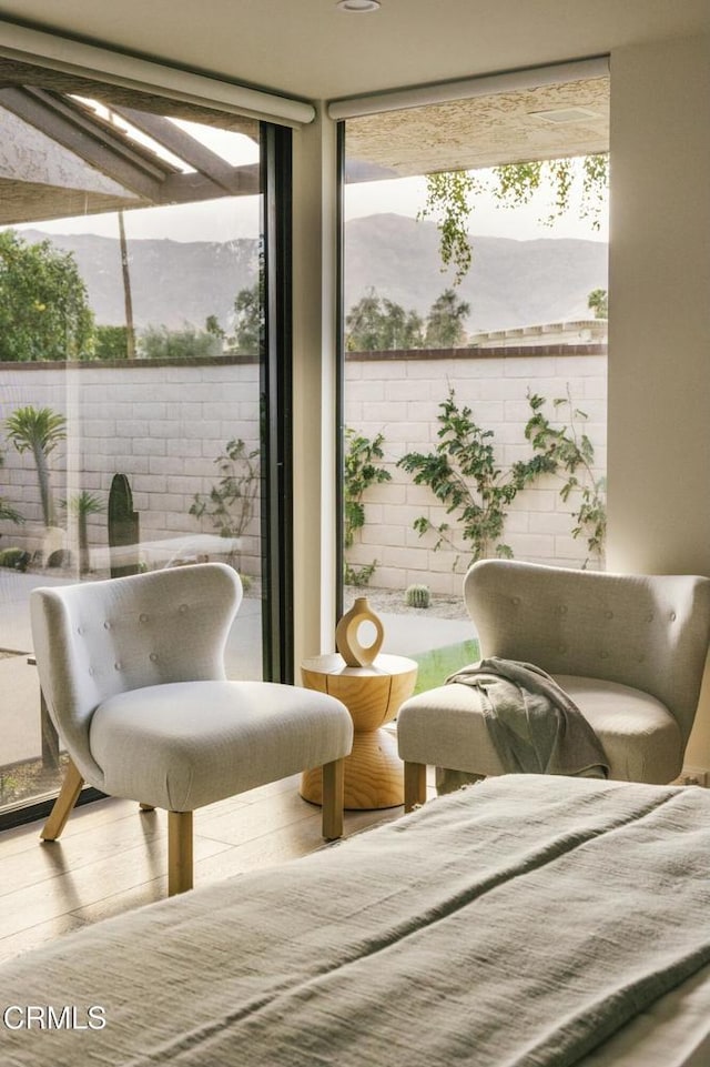 living area featuring a wall of windows and wood finished floors