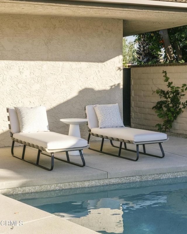 view of swimming pool featuring a patio and a fenced in pool