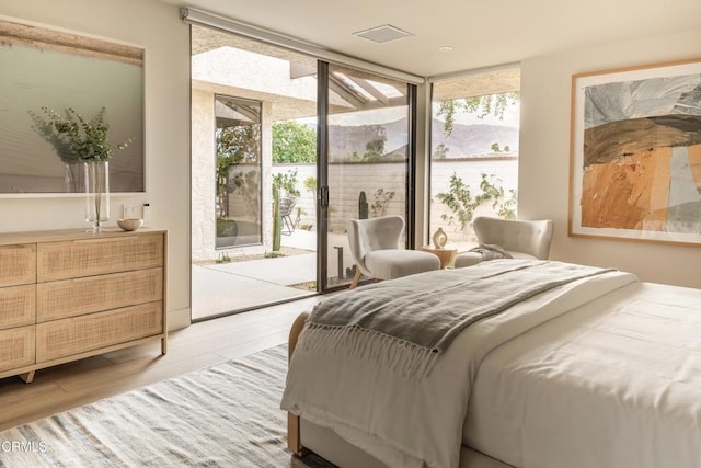 35 Lafayette Dr, Rancho Mirage, CA 92270 - bedroom featuring floor to ceiling windows, access to outside, multiple windows, and wood finished floors