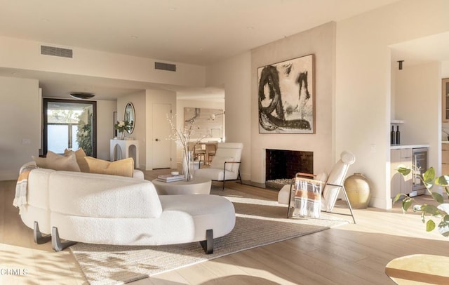 35 Lafayette Dr, Rancho Mirage, CA 92270 - living area with wood finished floors, a fireplace, and beverage cooler