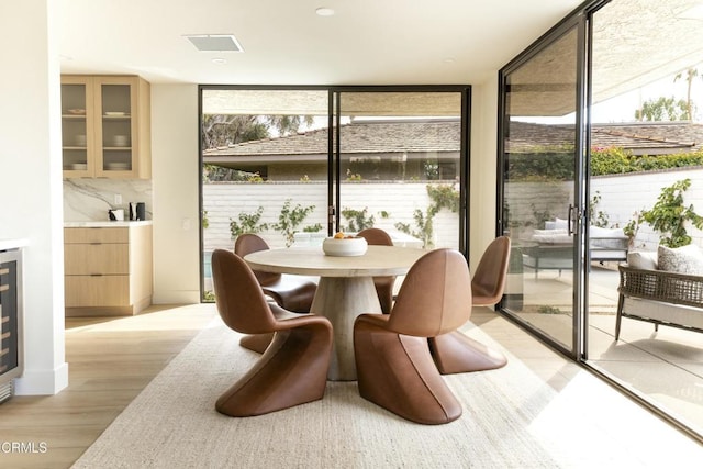 35 Lafayette Dr, Rancho Mirage, CA 92270 - dining area with a wall of windows, light wood-style flooring, and healthy amount of natural light
