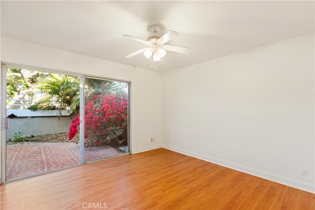 16061 Surprise Ln, Huntington Beach, CA 92649 - empty room featuring a healthy amount of sunlight, baseboards, and wood finished floors