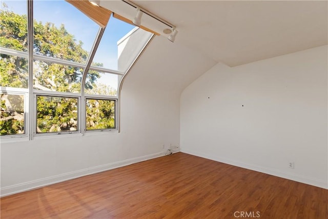 16061 Surprise Ln, Huntington Beach, CA 92649 - empty room featuring baseboards, wood finished floors, and a skylight