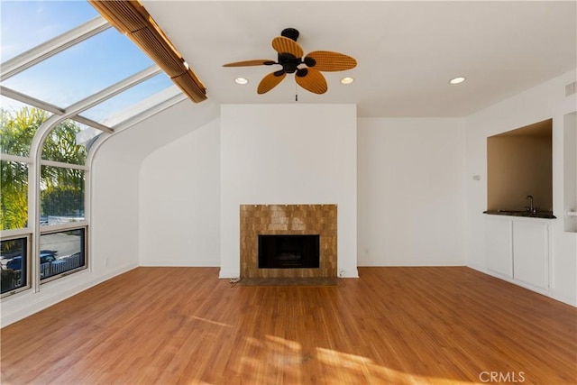 16061 Surprise Ln, Huntington Beach, CA 92649 - unfurnished living room featuring recessed lighting, wood finished floors, and a tile fireplace