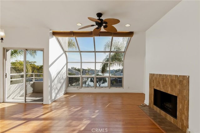 16061 Surprise Ln, Huntington Beach, CA 92649 - unfurnished living room featuring a ceiling fan, wood finished floors, baseboards, recessed lighting, and a tile fireplace