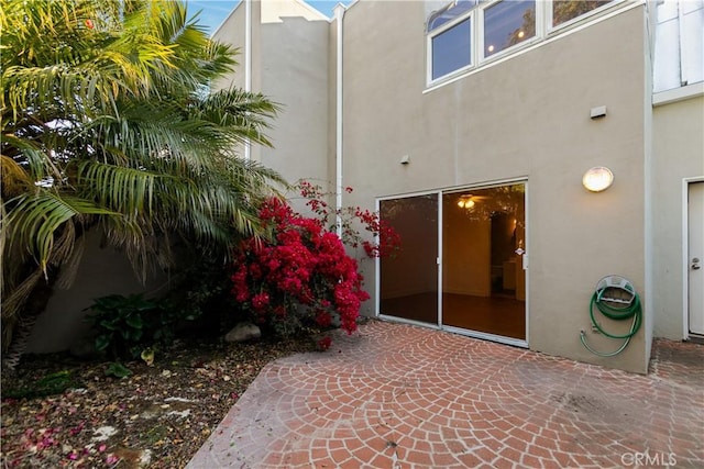 16061 Surprise Ln, Huntington Beach, CA 92649 - property entrance featuring a patio area and stucco siding