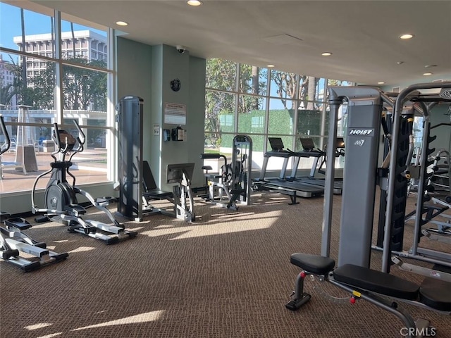 gym featuring a wall of windows and recessed lighting