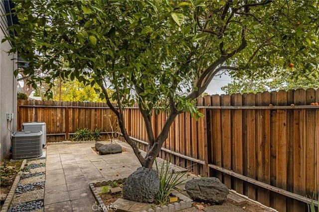 view of patio / terrace featuring cooling unit and a fenced backyard