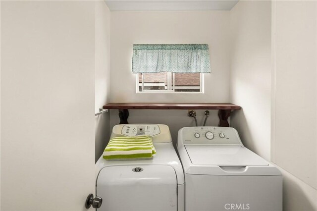 clothes washing area featuring laundry area and separate washer and dryer