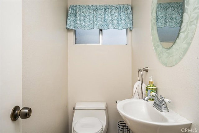 bathroom featuring toilet and a sink