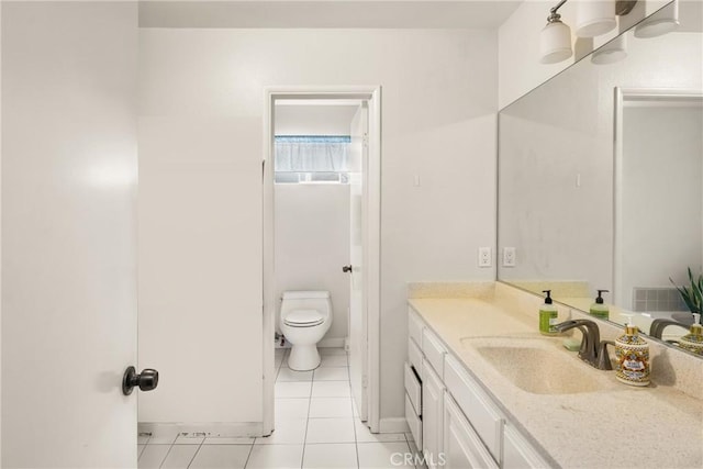 bathroom with vanity, tile patterned floors, and toilet