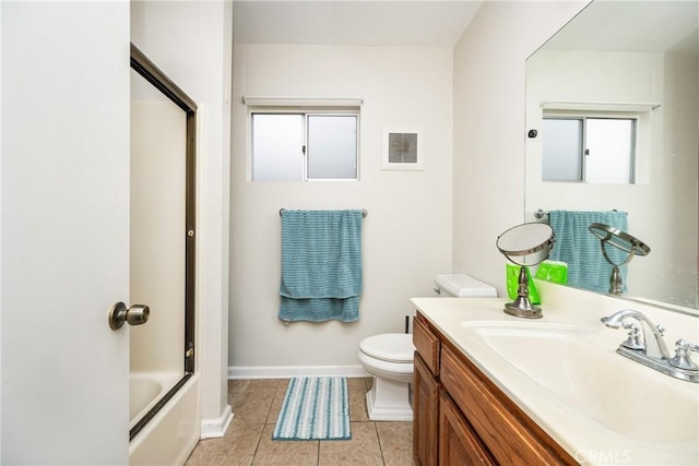 full bathroom with tile patterned flooring, toilet, vanity, and baseboards