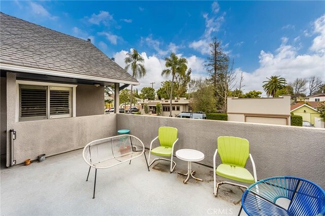 view of patio featuring a balcony