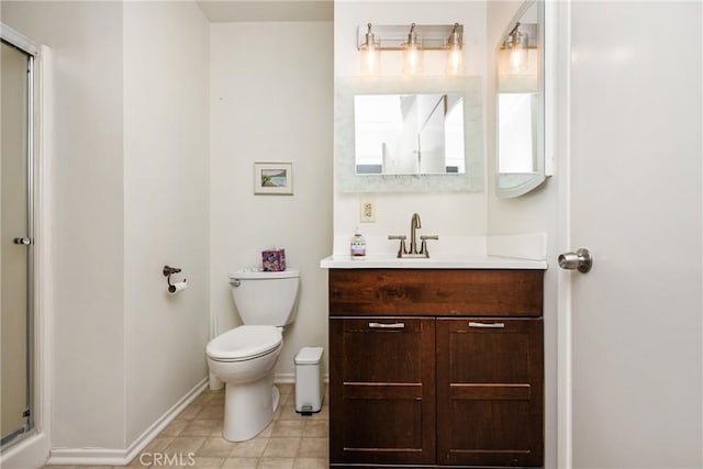 full bathroom featuring toilet, a shower with door, tile patterned flooring, baseboards, and vanity