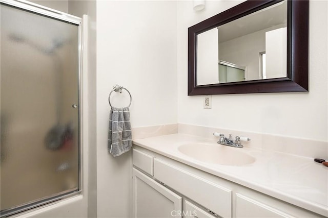 full bath featuring bath / shower combo with glass door and vanity