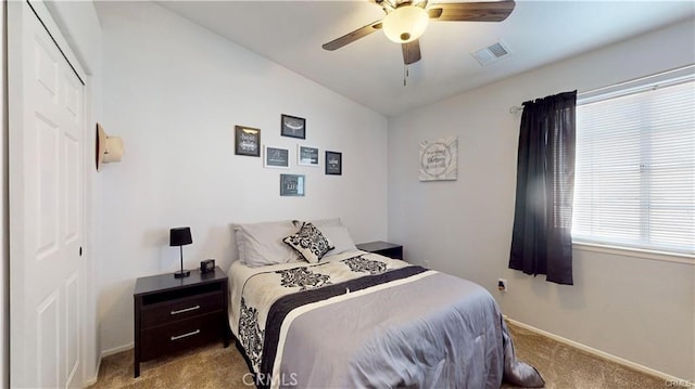 bedroom with a ceiling fan, visible vents, baseboards, a closet, and carpet flooring