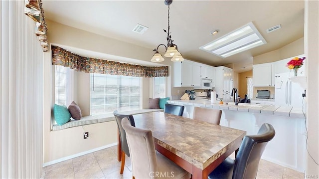 dining room with light tile patterned floors, baseboards, and visible vents