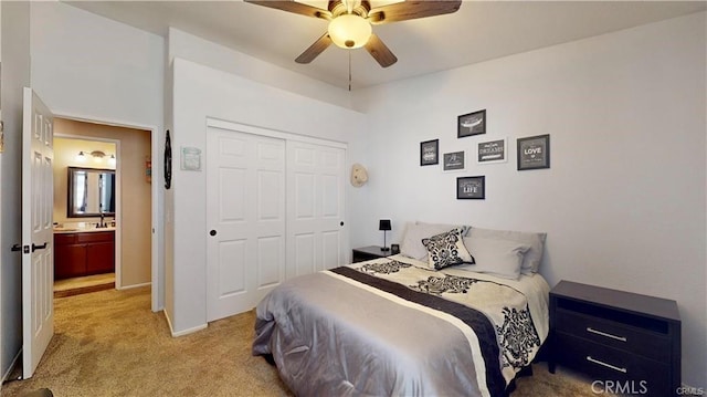 bedroom with a closet, baseboards, light colored carpet, and a ceiling fan