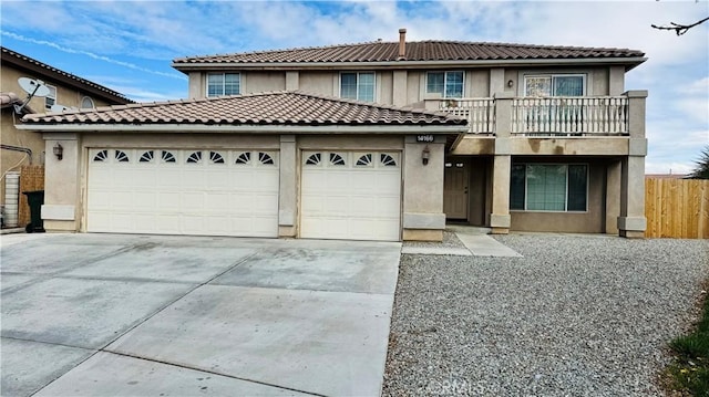 view of front of property with stucco siding, driveway, fence, a garage, and a balcony