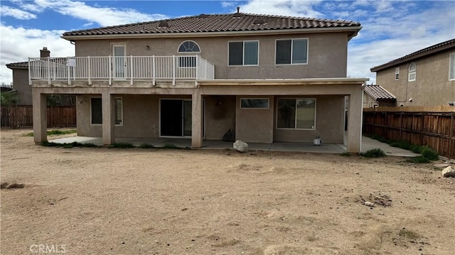 rear view of house featuring a patio area, a fenced backyard, and stucco siding