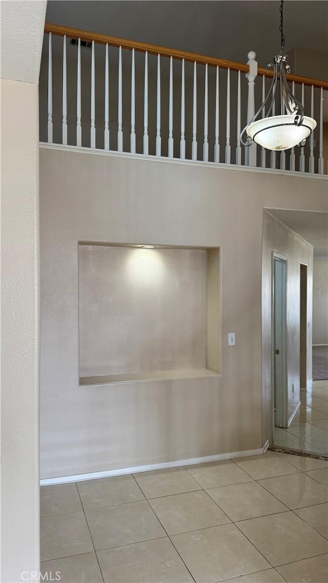 interior space featuring tile patterned floors and baseboards