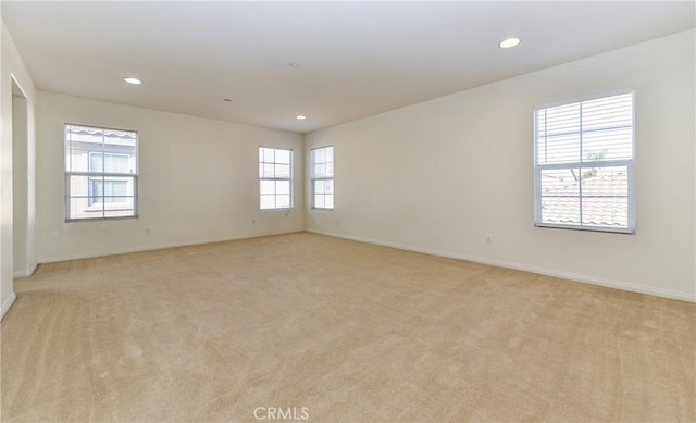 unfurnished room with recessed lighting, light colored carpet, and baseboards