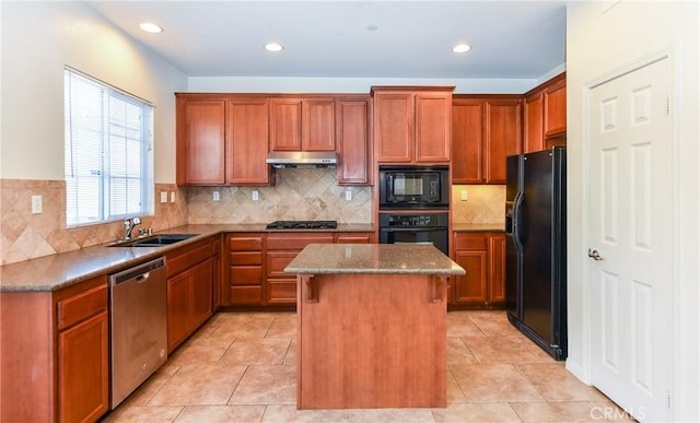 kitchen with black appliances, under cabinet range hood, a sink, a kitchen island, and light tile patterned floors