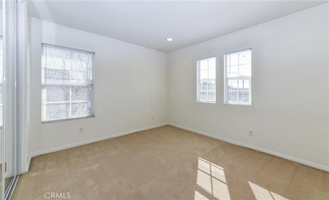 empty room with recessed lighting, baseboards, and carpet