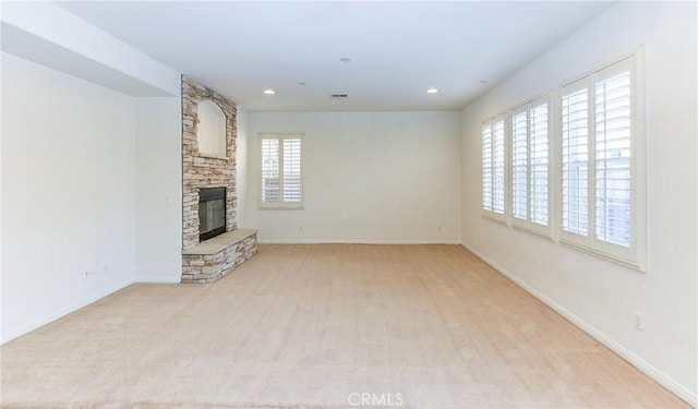 unfurnished living room featuring visible vents, recessed lighting, a fireplace, and baseboards