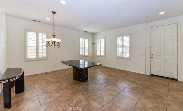 foyer with a wealth of natural light, visible vents, and baseboards