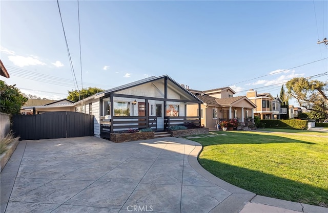 view of front of home with a front yard and fence