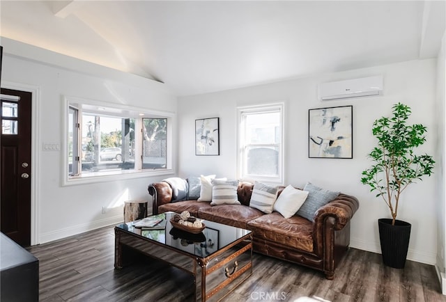 living area featuring lofted ceiling, plenty of natural light, wood finished floors, and a wall mounted AC