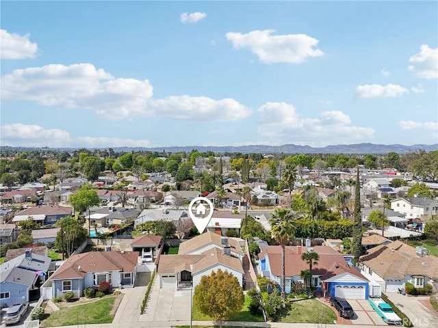 drone / aerial view featuring a residential view and a mountain view