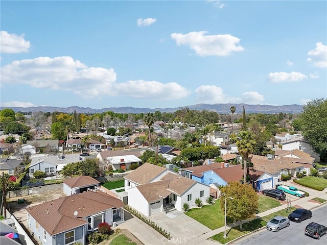 birds eye view of property with a mountain view and a residential view