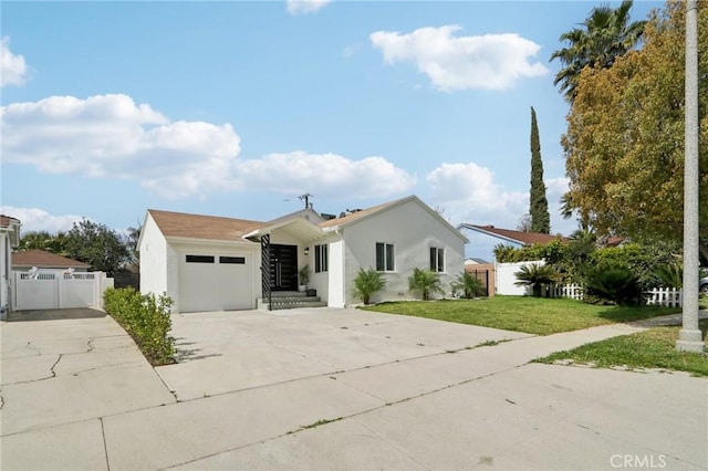 ranch-style home featuring stucco siding, driveway, fence, a front yard, and an attached garage