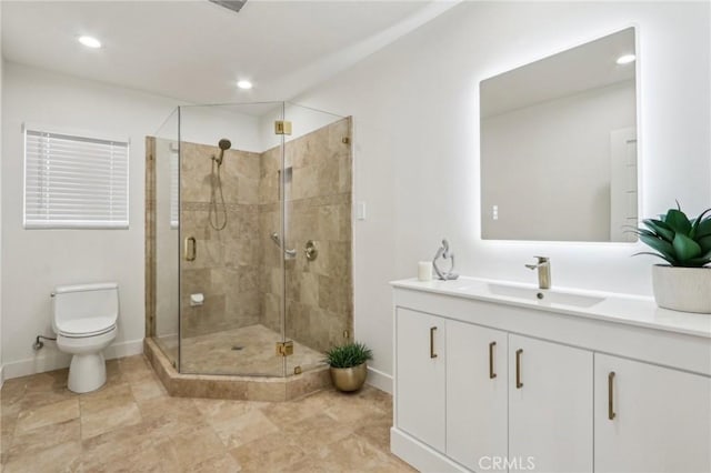 bathroom with toilet, a stall shower, recessed lighting, baseboards, and vanity