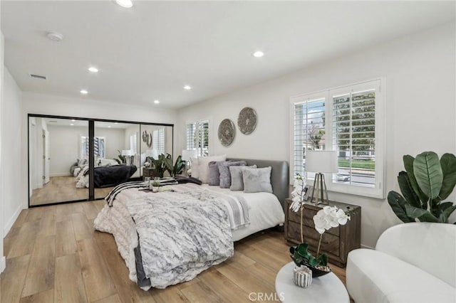 bedroom featuring recessed lighting, wood finished floors, visible vents, and baseboards