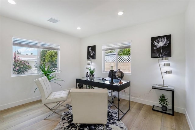 home office with plenty of natural light, recessed lighting, and light wood finished floors