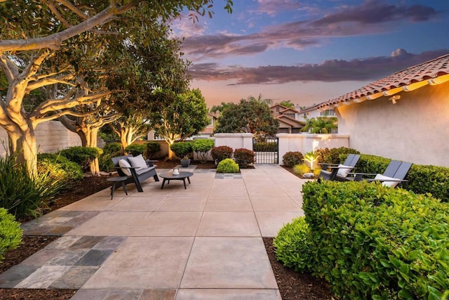 patio terrace at dusk with a gate and fence