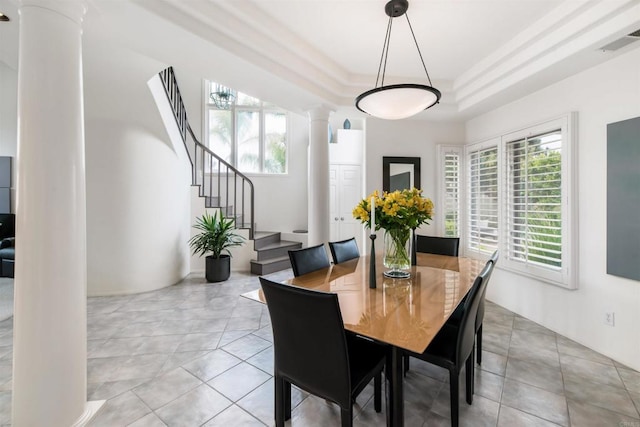 dining room featuring decorative columns, plenty of natural light, a raised ceiling, and visible vents