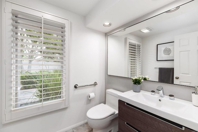 bathroom featuring vanity, toilet, recessed lighting, and baseboards